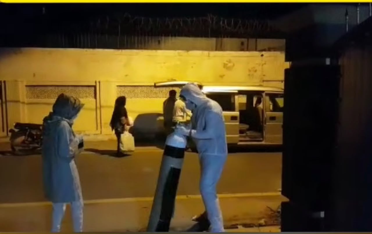 Health Warriors volunteers handling an oxygen cylinder during nighttime field support
