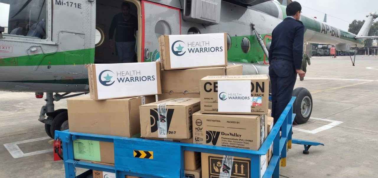 Health Warriors medicine cartons prepared beside a helicopter